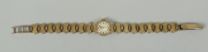 A 9CT YELLOW GOLD LADIES BRACELET WATCH BY ROTARY '21 JEWELS' with winding mechanism on a textured