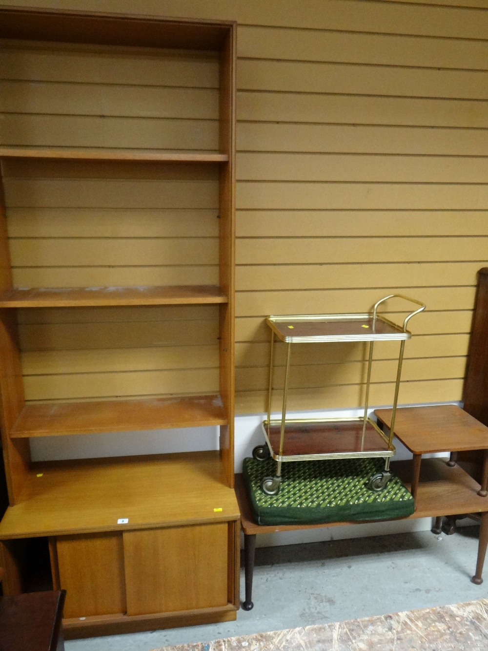 A parcel of furniture including tea trolley, telephone table, bookcase and sliding door teak