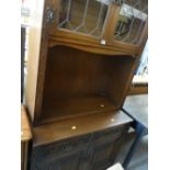 A linen fold bookcase with cupboard base