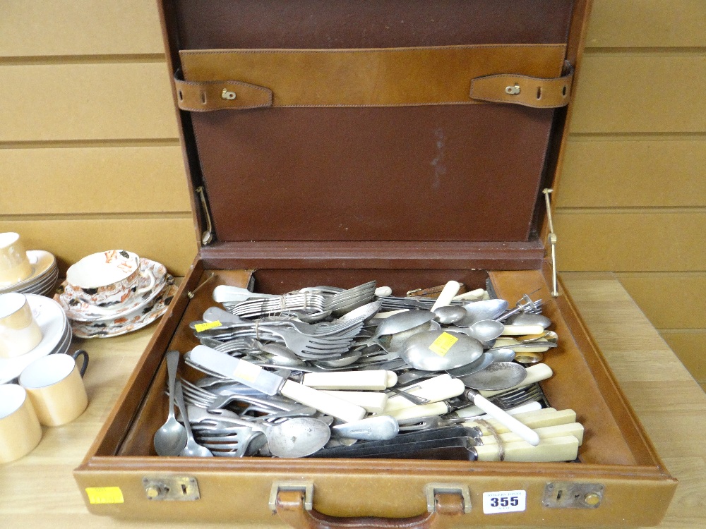 A briefcase containing a large quantity of mixed loose cutlery
