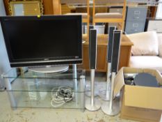 A Sony Bravia 43-inch flatscreen TV on stand with surround sound speakers and other equipment
