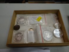 Small pine box containing an American silver dollar, Falklands crown, Canadian maple dollar etc