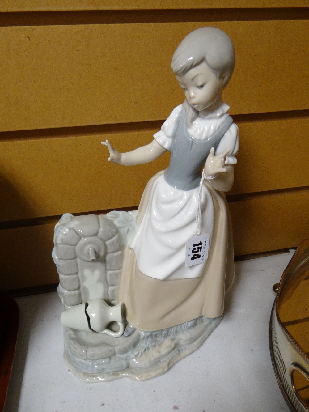 A Nao figure of a child with broken water vessel