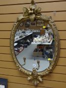 An antique gilt framed mirror with candelabra