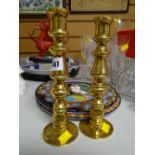 A pair of unusual heavy brass candlestick holders