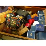 A box of needlework items including vintage pin cushions etc