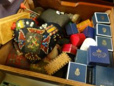 A box of needlework items including vintage pin cushions etc