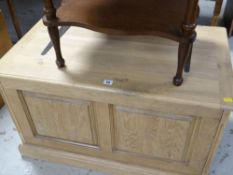 A modern lightwood panelled blanket chest or toy box with large metal hinges