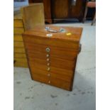 A portable specimen cabinet of six drawers and hinging lid