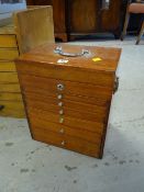 A portable specimen cabinet of six drawers and hinging lid