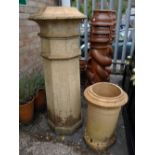 A pale terracotta tall chimney pot together with another