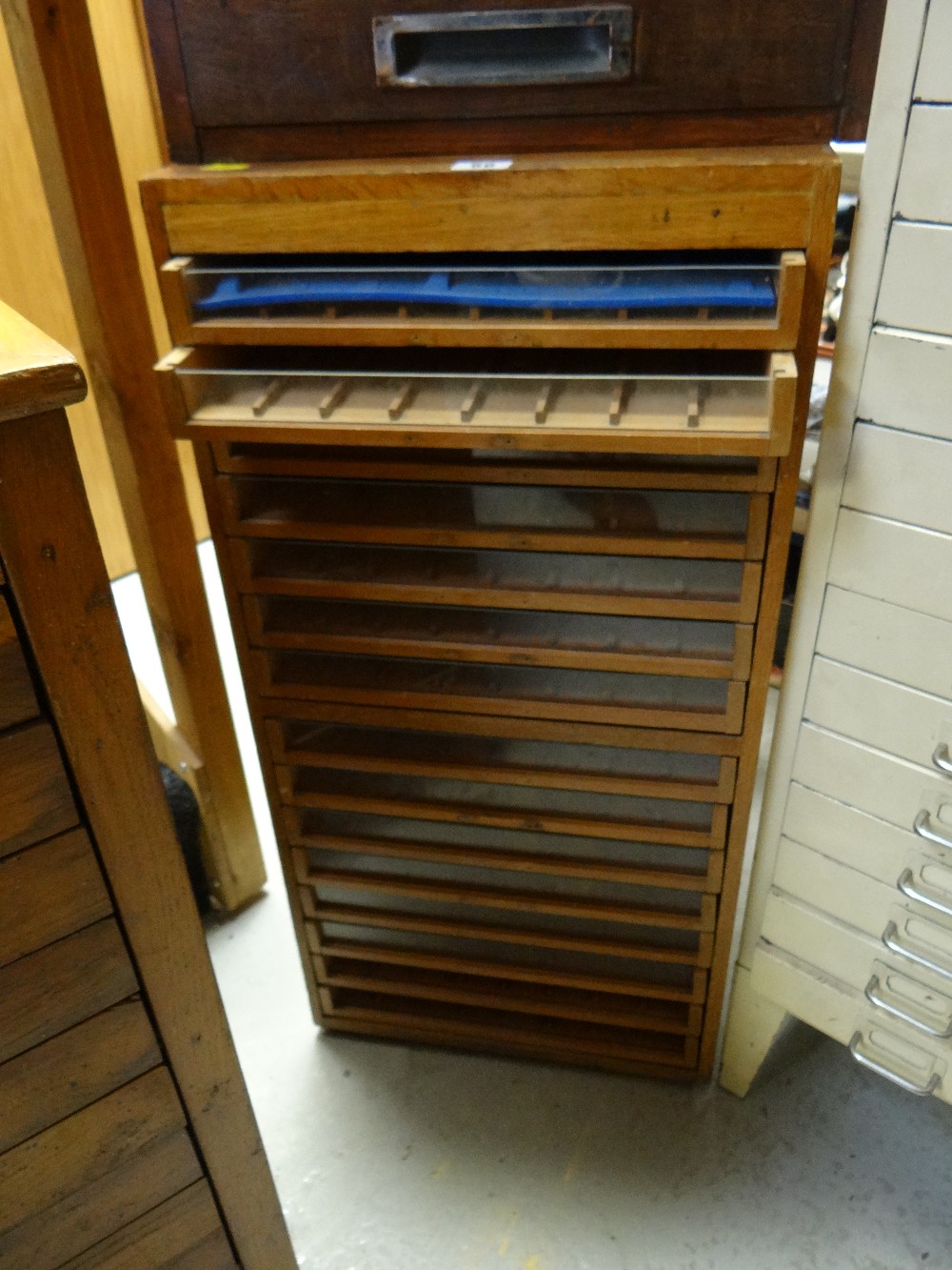 A fifteen-drawer retailers cabinet for Dewhurst's Thread with painted label to each side