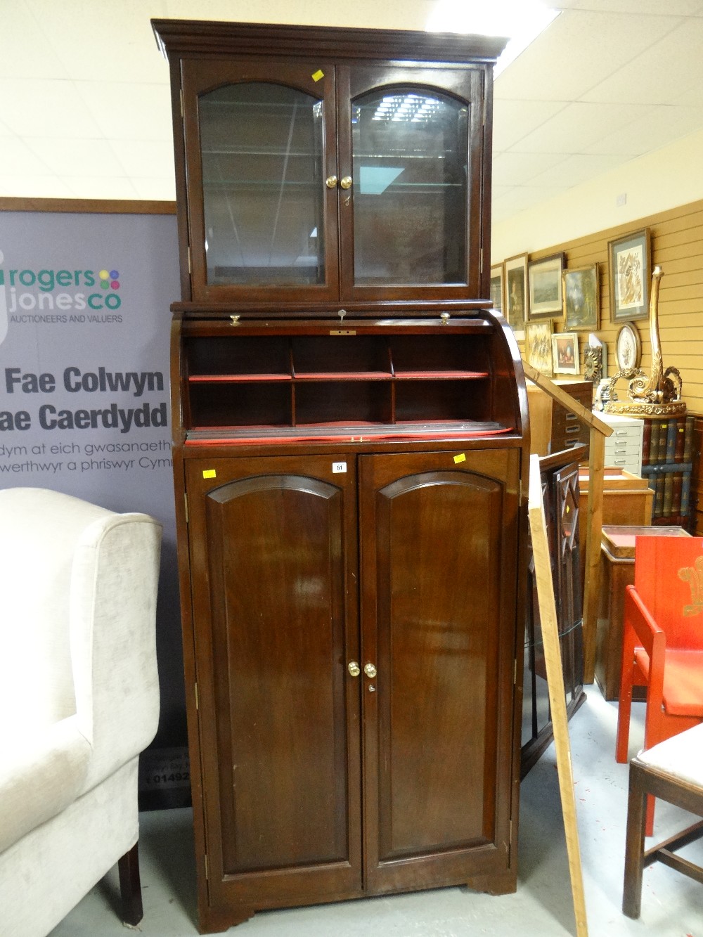 An unusual mahogany specimen cabinet with a tall two-door base revealing twenty long shallow drawers