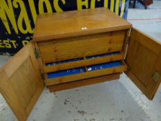 A good specimen cabinet in light wood with two facade doors revealing six inner long shallow