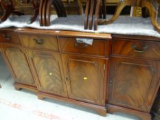 A Burton reproduction furniture breakfront sideboard in mahogany finish