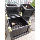 Five good square painted planked garden planters together with a wheelbarrow