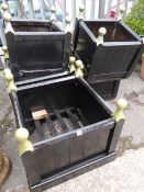 Five good square painted planked garden planters together with a wheelbarrow