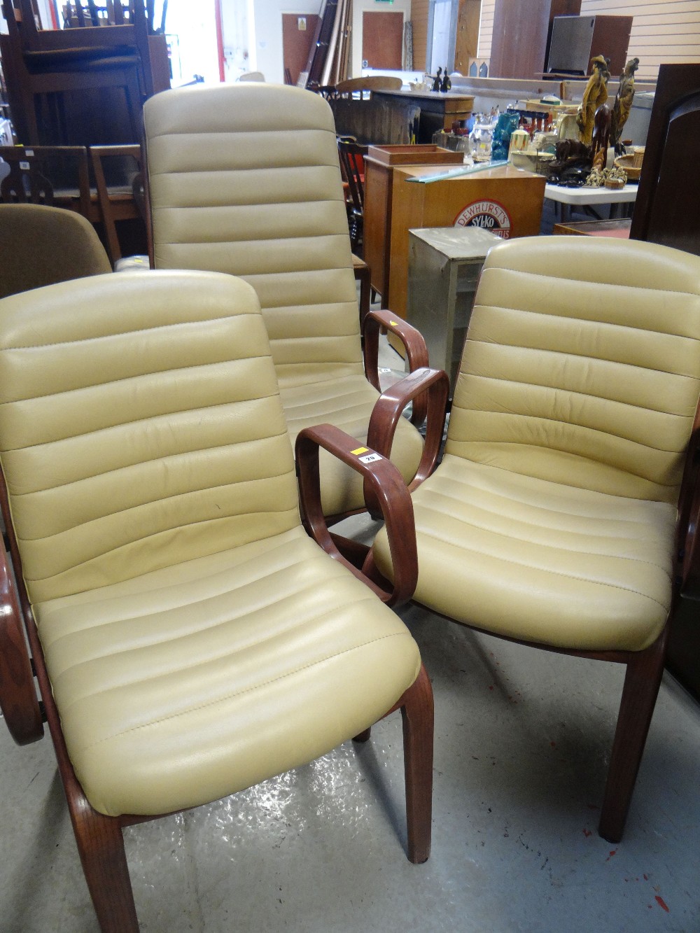 A tall back leather office chair and a pair of matching office armchairs
