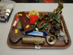 A tray of various collectables including novelty corkscrews, bottle openers, pin badges, dressing