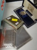 Two silver cigarette cases and another and a cased silver medallion