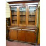 A VICTORIAN MAHOGANY BOOKCASE SIDEBOARD having an inverted stepped cornice over twin glazed doors