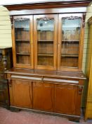 A VICTORIAN MAHOGANY BOOKCASE SIDEBOARD having an inverted stepped cornice over twin glazed doors