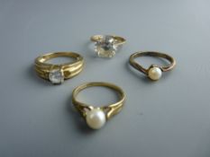 A NINE CARAT GOLD CUBIC ZIRCON SOLITAIRE DRESS RING, two solitaire pearl dress rings and a nine