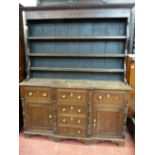 AN ANGLESEY OAK BREAKFRONT DRESSER, the three shelf backed boarded rack with inlaid diamond and star