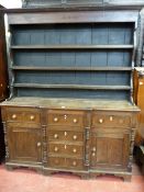 AN ANGLESEY OAK BREAKFRONT DRESSER, the three shelf backed boarded rack with inlaid diamond and star