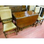 AN OAK BARLEY TWIST GATE LEG DINING TABLE with piecrust edging, along with a set of four oak