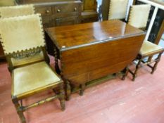 AN OAK BARLEY TWIST GATE LEG DINING TABLE with piecrust edging, along with a set of four oak