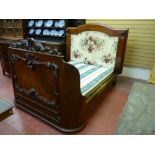 A VICTORIAN MAHOGANY BED, the rear headboard with arched top and side moulding, the head section