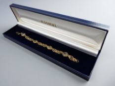 A NINE CARAT GOLD FANCY LINK BRACELET having four oval blue quartz stones, 5.5 grms