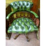 AN ANTIQUE STYLE CAPTAIN'S CHAIR in green button back leather effect upholstery, with a curved