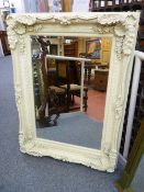 A REPRODUCTION PLASTER MOULDED FRAMED MIRROR with bevelled edge glass, 120 x 90 cms