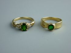 A NINE CARAT GOLD DRESS RING with oval diopside and tiny diamonds and a nine carat gold dress ring