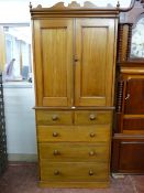 A VICTORIAN PINE PRESS CUPBOARD with decorative top detail over two cupboard doors with interior