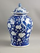 A 19th CENTURY CHINESE PRUNUS DECORATED JAR & COVER, 33 cms high, underglazed blue, six character