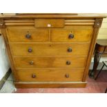 A LATE VICTORIAN MAHOGANY CHEST of two short over three long drawers with turned wooden knobs and