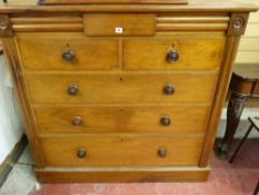 A LATE VICTORIAN MAHOGANY CHEST of two short over three long drawers with turned wooden knobs and