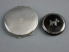 TWO SILVER POWDER COMPACTS, a 5 cms diameter black enamel example set with a marcasite Scottie dog