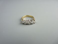 AN EIGHTEEN CARAT GOLD FIVE STONE DIAMOND RING, the centre stone of visual estimate 0.5 carat with