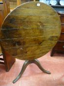 AN ANTIQUE OAK TILT TOP TRIPOD TABLE, the 82.5 cms diameter top on a turned column support with