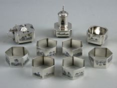 A POSSIBLY EGYPTIAN NINE PIECE CRUET & NAPKIN RING SET, the unmarked white metal decorated with