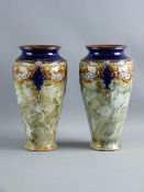 A PAIR OF ROYAL DOULTON NARROW BASED TAPERED VASES, green mottled glazed ground with attractive