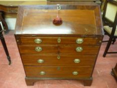 A GEORGIAN MAHOGANY FALL FRONT BUREAU, the drop down crossbanded fall opening to reveal an