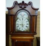 A VICTORIAN MAHOGANY LONGCASE CLOCK by S Bibby, Carnarvon, the painted arched dial set with Roman