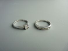 TWO WHITE GOLD DIAMOND SET RINGS including a nine carat diamond solitaire in an illusion setting,