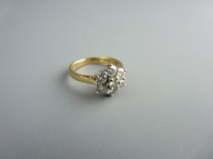 AN EIGHTEEN CARAT GOLD SEVEN STONE DIAMOND CLUSTER DRESS RING, total visual estimate 1.4 carats, 4.7