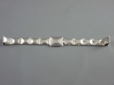 A THIRTY INCH STERLING SILVER BELT, twenty three hinged rectangular sections, the buckle marked '